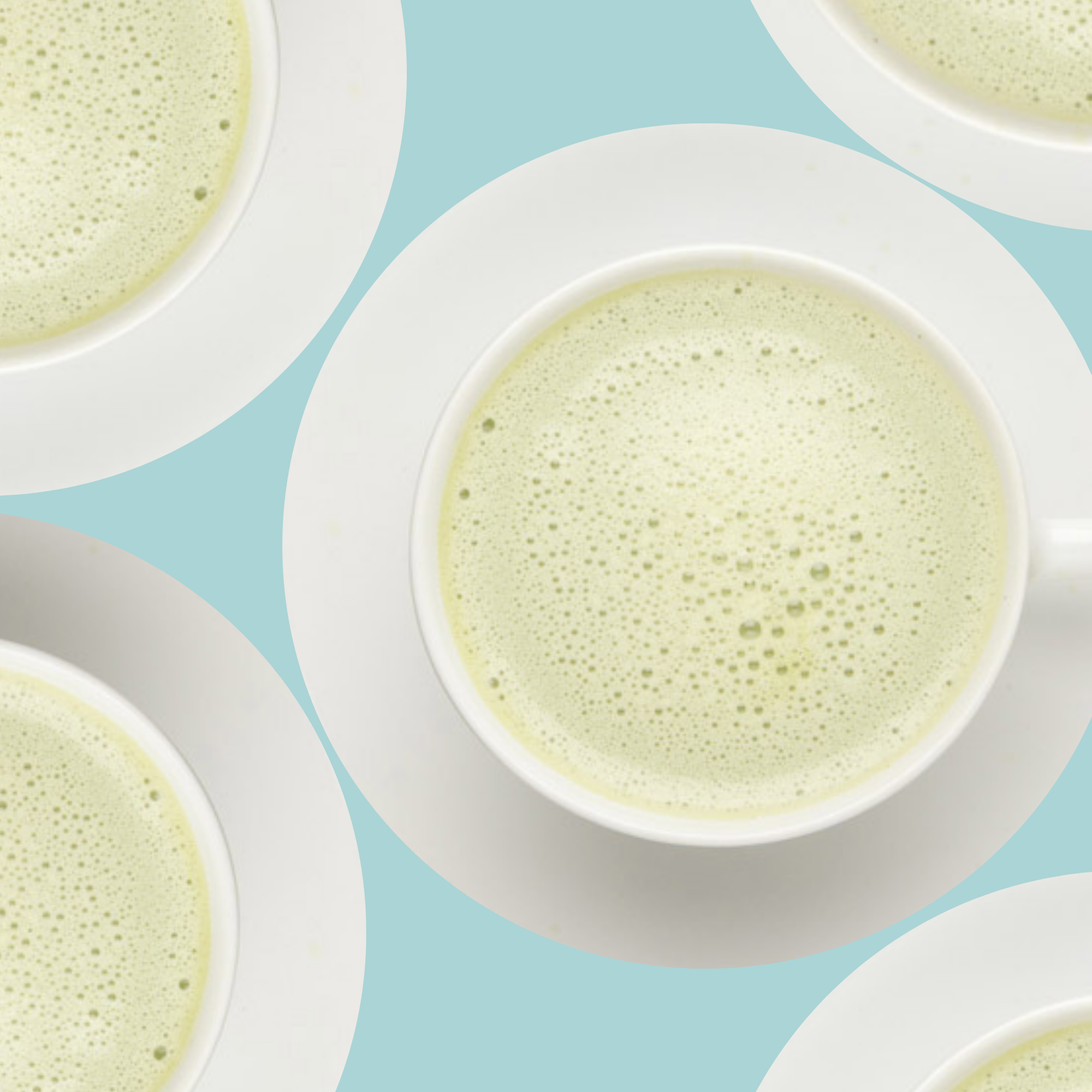 Multiple white bowls filled with a brewed matcha on a blue background